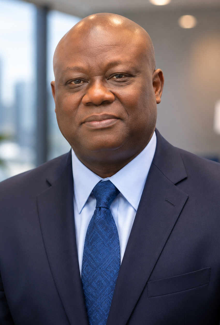 Professional headshot of Chouaib "Jacob" Coulibaly, licensed health insurance agent at Affordable Care Agents, wearing a navy business suit with a blurred modern office background.
